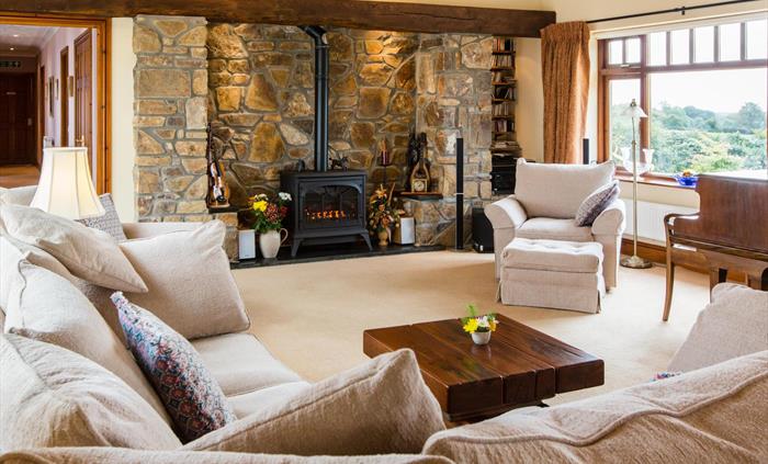Music room; corner settee, fireplace and piano.